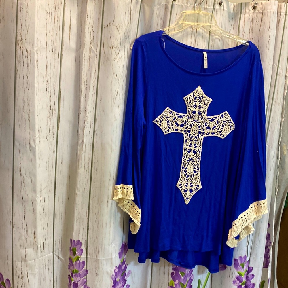 The Hanger Size 1X in the color Blue with cream embroidered details.